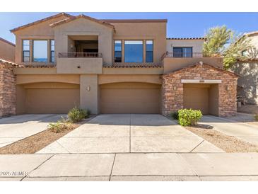 Charming townhouse featuring multiple car garages and lovely architecture at 19550 N Grayhawk Dr # 1044, Scottsdale, AZ 85255