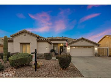 Charming single-story home with a well-manicured desert landscape and a spacious two-car garage at 25454 N 73Rd Ave, Peoria, AZ 85383