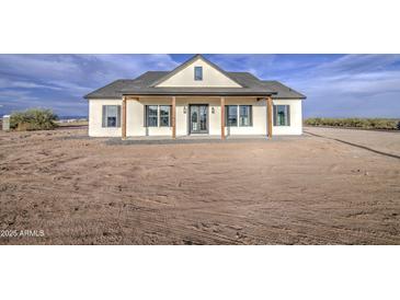 Charming single-story home featuring a welcoming front porch and modern farmhouse design in a spacious lot at 28003 N Faded Creek Dr, Florence, AZ 85132