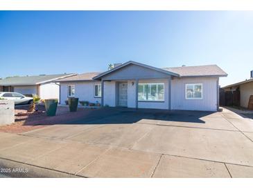 Charming single-story home with a well-maintained front yard and a concrete driveway on a sunny day at 7217 W Claremont St, Glendale, AZ 85303