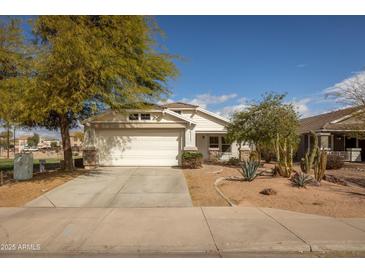 Charming single-story home with a two-car garage, xeriscaped front yard, and stone accents at 10656 E Plata Ave, Mesa, AZ 85212