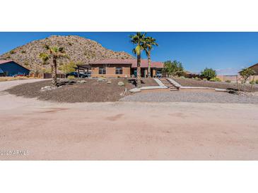 Charming single-story home with desert landscaping and steps leading to the front entrance at 1440 W Christie Lyn Ln, San Tan Valley, AZ 85144