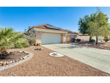 Charming single-story home featuring a spacious garage, desert landscaping, and a red tile roof at 15840 W Falcon Ridge Dr, Sun City West, AZ 85375