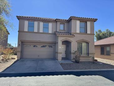 Two-story home featuring a tile roof, neutral stucco, two-car garage, and decorative window shutters at 16939 W Marconi Ave, Surprise, AZ 85388