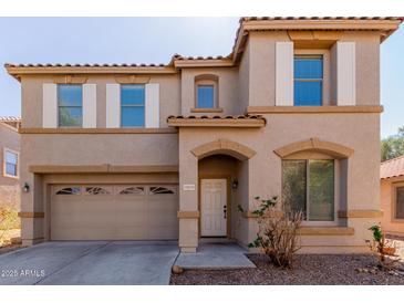 Charming two-story home featuring a two-car garage and an arched entryway for welcoming guests at 16939 W Marconi Ave, Surprise, AZ 85388