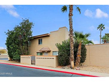 Inviting two-story townhouse with desert landscaping and mature palm trees for relaxed curb appeal at 17056 E Calle Del Oro Dr # B, Fountain Hills, AZ 85268