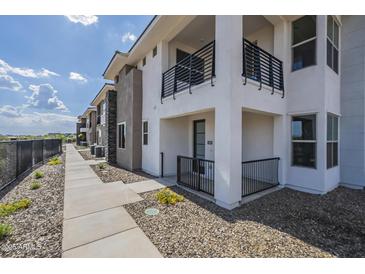 Modern townhome featuring a private balcony and landscaped front yard, perfect for outdoor enjoyment at 2121 W Sonoran Desert Dr # 93, Phoenix, AZ 85085