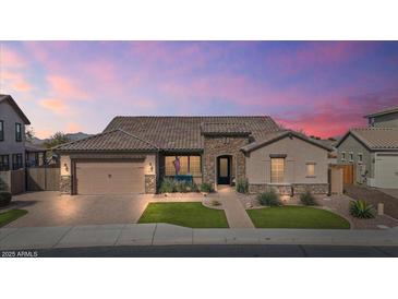 Charming home featuring a desert landscape, stone accents, and a tile roof under a colorful evening sky at 2928 E Palm St, Mesa, AZ 85213