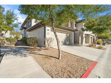 Two-story home showcasing a two-car garage, low maintenance landscaping and a concrete driveway at 33575 N Dove Lakes Dr # 2028, Cave Creek, AZ 85331