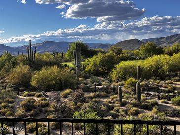 Expansive desert landscape featuring a picturesque mountain range under a partly cloudy sky at 36601 N Mule Train N Rd # D16, Carefree, AZ 85377