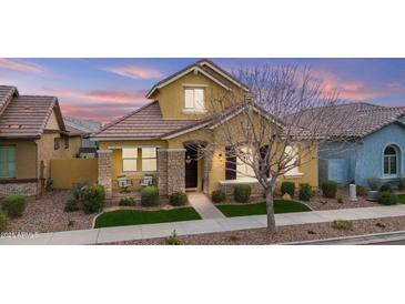 Charming, two-story home featuring stone accents, covered porch, and manicured landscaping at 4457 E Bernice St, Gilbert, AZ 85295