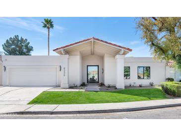 Charming one-story home with a well-manicured lawn and attached two-car garage at 8336 N 72Nd Pl, Scottsdale, AZ 85258