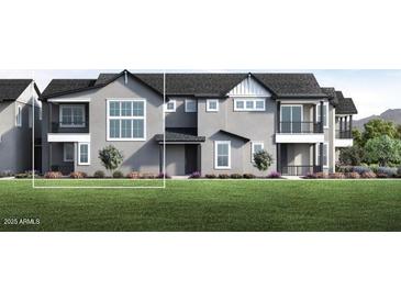 Modern two-story townhome featuring neutral stucco, large windows, private balconies and a well-manicured lawn at 11300 N Casa Dega Dr # 1020, Surprise, AZ 85388