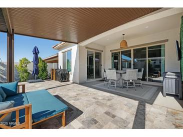 Spacious covered patio with seating, dining area, and outdoor amenities, perfect for entertaining at 12047 E Sereno Rd, Gold Canyon, AZ 85118