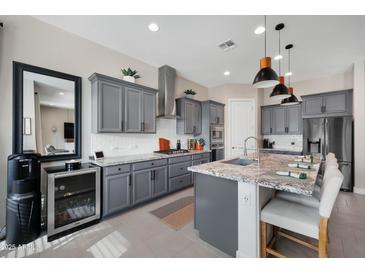 Well-appointed kitchen with gray cabinetry, stainless steel appliances, and granite countertops at 12047 E Sereno Rd, Gold Canyon, AZ 85118