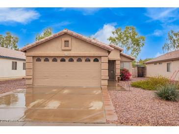 Charming single-Gathering home boasting a two-car garage, manicured landscaping, and a well-maintained front yard at 16737 N 157Th Ave, Surprise, AZ 85374