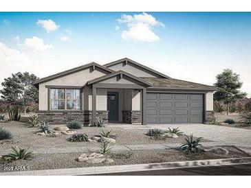 Charming single-story home with a neutral color scheme, desert landscaping, and a two-car garage, creating a welcoming curb appeal at 17310 W Via Dona Rd, Surprise, AZ 85387