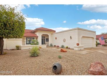 Charming single-story home featuring a red tile roof, low-maintenance landscaping, and an attached two-car garage at 19835 N Alta Loma Dr, Sun City West, AZ 85375