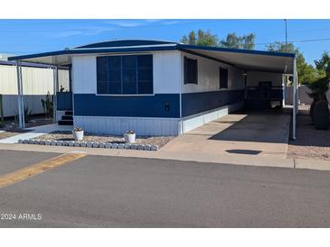 Charming mobile home featuring covered parking and white and blue color scheme at 205 S Higley Rd # 8, Mesa, AZ 85206