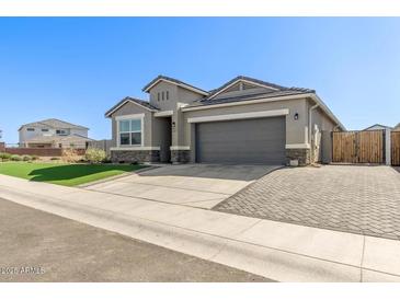 Charming single-story home featuring a well-manicured lawn, a two-car garage and neutral color palette at 36708 N Petra Dr, San Tan Valley, AZ 85143