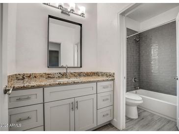 Bathroom featuring granite countertops, soft close cabinets, and a modern shower with stylish tile at 38538 W San Juan Ave, Tonopah, AZ 85354