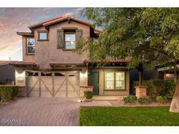Charming two-story home featuring a paved driveway and a well-manicured lawn at 4084 E Rawhide St, Gilbert, AZ 85296