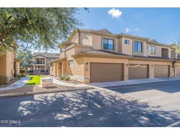 A tan two-story townhome with a two-car garage and low-maintenance landscaping at 705 W Queen Creek Rd # 2158, Chandler, AZ 85248