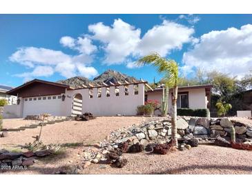 Single level house showcasing desert landscaping, mountain views, and a unique exterior design at 7607 N 22Nd Pl, Phoenix, AZ 85020