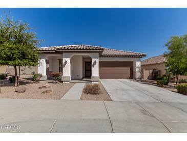 Charming single-story home with a well-manicured yard and a two-car garage at 11915 S 184Th Ave, Goodyear, AZ 85338