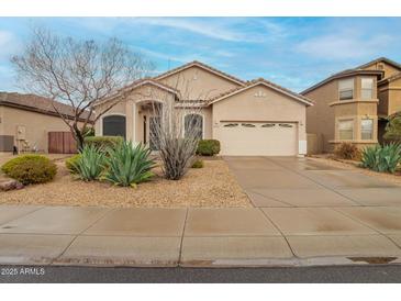 Charming single-Gathering home featuring a low-maintenance desert landscape and a two-car garage at 26065 N 68Th Ln, Peoria, AZ 85383