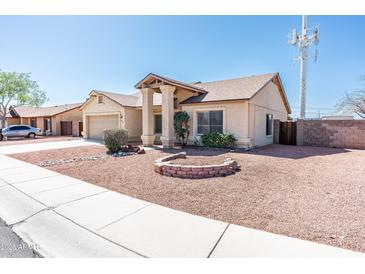 Inviting single-story home with a well-maintained, low-maintenance front yard landscape at 8818 N 110Th Ave, Peoria, AZ 85345