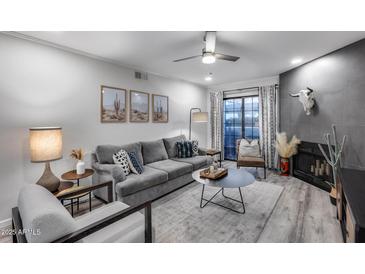 Inviting living room features modern decor, gray sofa, unique accents, and lots of natural light at 11011 N 92Nd St # 1157, Scottsdale, AZ 85260