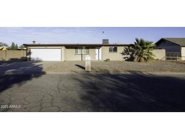 Charming single-story home with desert landscaping, attached garage, and a quaint front yard at 1518 N Gilbert Ave, Casa Grande, AZ 85122