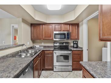 Well-lit kitchen features stainless steel appliances and ample cabinet space for storage at 17017 N 12Th St # 1106, Phoenix, AZ 85022