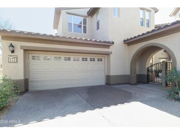 Attached two car garage, paved drive, and gated entrance, providing convenient parking and security at 20802 N Grayhawk Dr # 1151, Scottsdale, AZ 85255