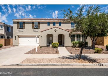 Charming two-story home featuring a two-car garage, landscaped yard, and a welcoming front porch at 21030 E Misty Ln, Queen Creek, AZ 85142