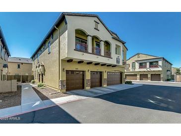Beautiful townhome showcasing balconies, three garages, and tasteful desert landscaping at 2725 E Mine Creek Rd # 2186, Phoenix, AZ 85024