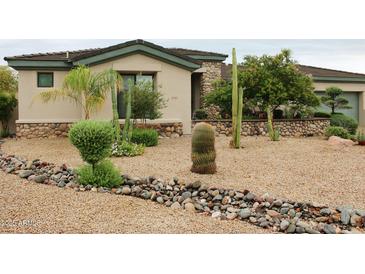 Beautiful Southwestern home featuring native landscaping and desert-friendly plants and rock at 3957 N 148Th Dr, Goodyear, AZ 85395