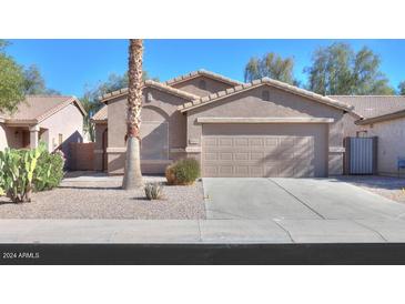 Charming single Gathering home, well manicured desert landscaping, and a spacious two-car garage at 43409 W Sagebrush Trl, Maricopa, AZ 85138