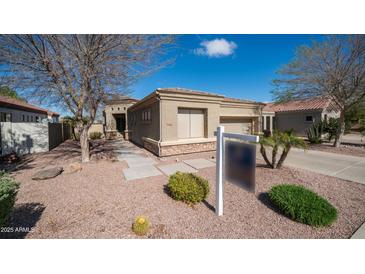 Beautiful single-story home with desert landscaping and stone accents on a sunny day at 6774 S Pinehurst Dr, Gilbert, AZ 85298