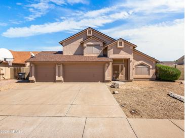 Charming two-story home featuring a three-car garage and low-maintenance desert landscaping at 14317 N 78Th Dr, Peoria, AZ 85381