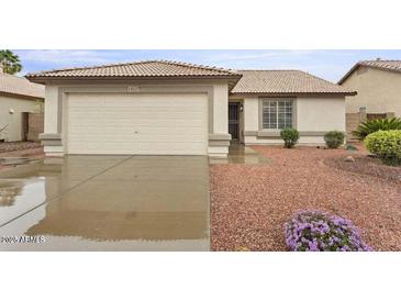 Charming single-story home featuring a two car garage and low maintenance desert landscaping at 14527 W Marcus Dr, Surprise, AZ 85374