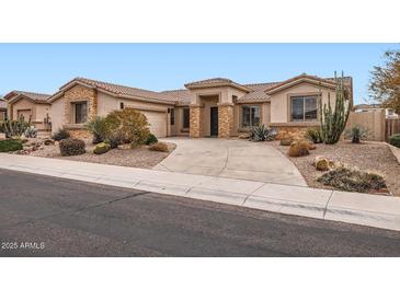 Charming home with desert landscaping, stone accents, and a tile roof at 22181 N 78Th St, Scottsdale, AZ 85255