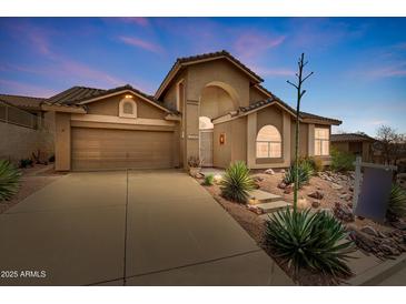 Charming two-story home features a desert landscaped front yard and attached two-car garage at 4903 S Desert Willow Dr, Gold Canyon, AZ 85118