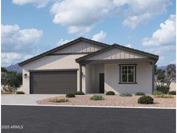 Charming single-story home with a neutral color scheme, two-car garage, and low maintenance landscaping at 5519 S 240Th Ln, Buckeye, AZ 85326