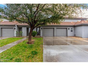 Charming townhome with two-car garage, tile roof, and mature landscaping at 7401 W Arrowhead Clubhouse Dr # 1006, Glendale, AZ 85308