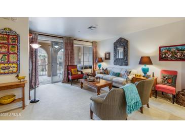 Bright living room with comfy seating and balcony access, perfect for relaxing and entertaining at 10655 N 9Th St # 207, Phoenix, AZ 85020