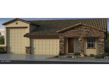 Charming home featuring a three-car garage, a stone facade, and a covered entryway at 5445 N 178Th Ave, Litchfield Park, AZ 85340