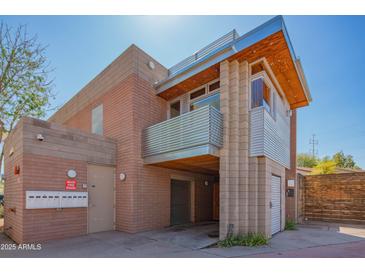 Unique building featuring metal siding, brick accents, and a balcony at 920 S Ash Ave, Tempe, AZ 85281