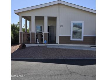 Charming single-story home with a welcoming covered porch and well-maintained gravel landscaping at 11596 W Sierra Dawn Blvd # 293, Surprise, AZ 85378